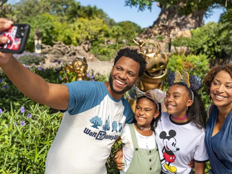 Family taking selfie in front of the tree of life at Animal Kingdom Theme park