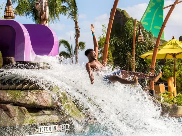 Guest splashing down on Ohno Drop Slide at Universal's Volcano Bay