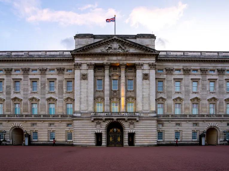 The front of Buckingham Palace with the Union Jack flying 