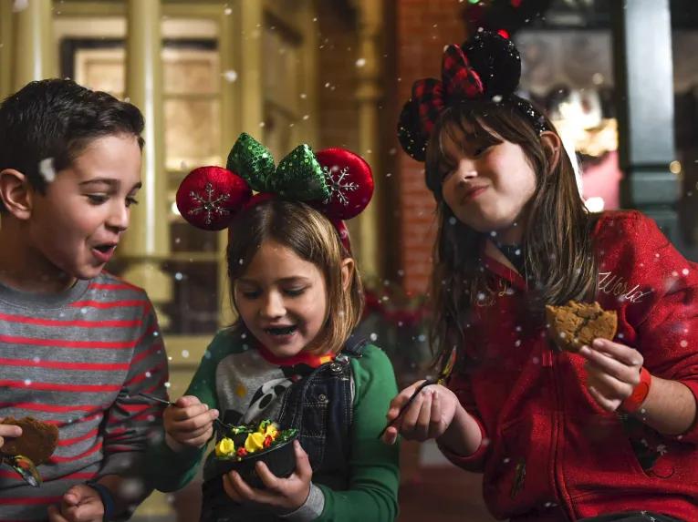 Guests enjoying yuletide treats at Mickey’s Very Merry Christmas Party in Magic Kingdom Park