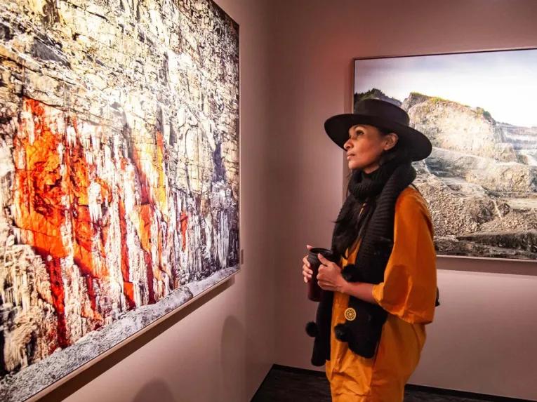 Woman looking at a painting inside the MET New York