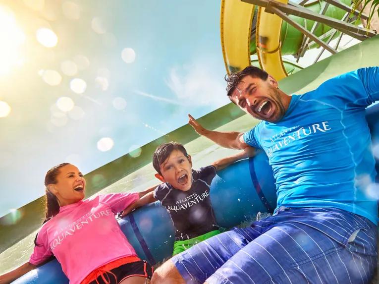 Family enjoying Aquaconda water slide at Aquaventure Dubai