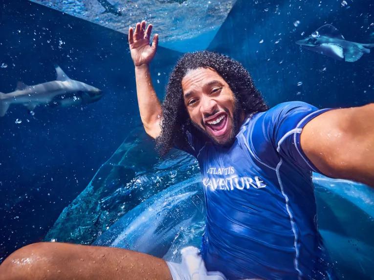 Man sliding along Shark Attack waterslide at Aquaventure Dubai