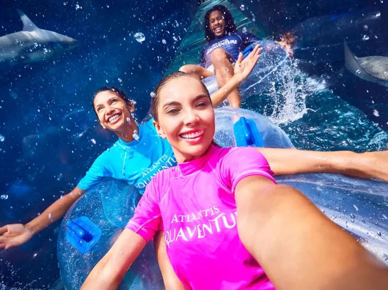 Friends riding Shark Attack waterslide at Aquaventure Dubai