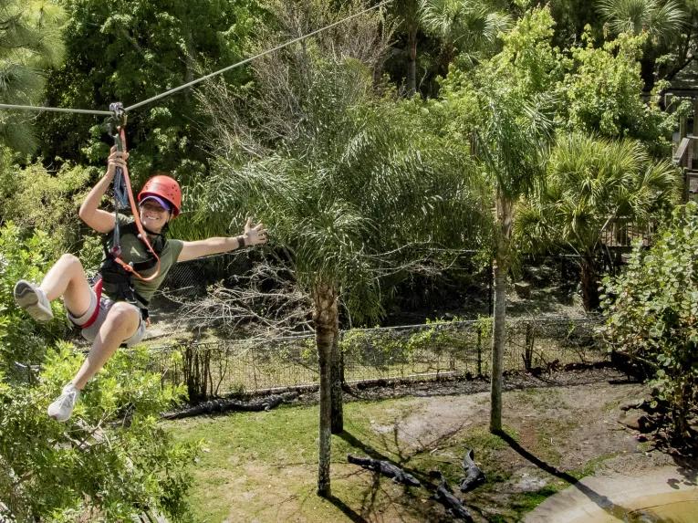 Woman riding the Gatorland Screamin’ Gator Zip Line