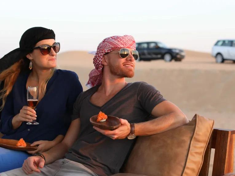 Guests enjoying drinks and canapes on the Platinum Heritage Safari in the Dubai Desert