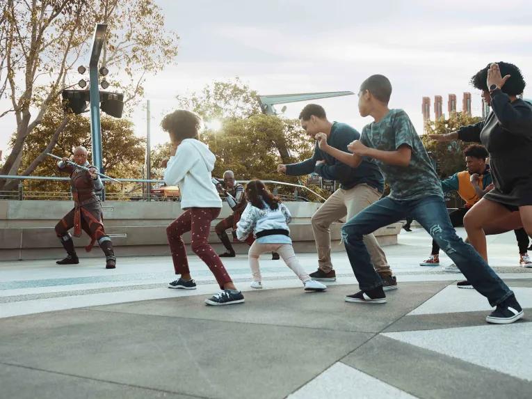 Guests training alongside Dora Milaje and General Okoye at Warriors of Wakanda, Avengers Campus at Disney California Adventure Park