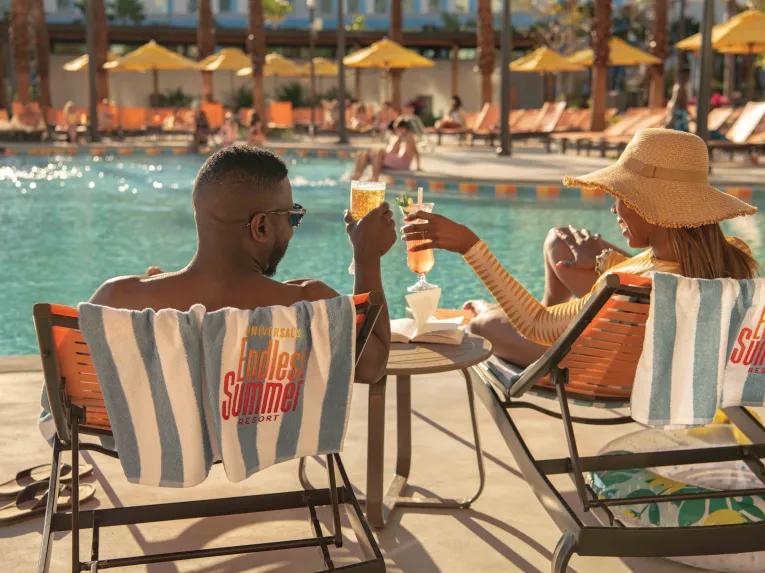 Guests have a drink next to the pool at Universal's Endless Summer Resort - Dockside Inn and Suites