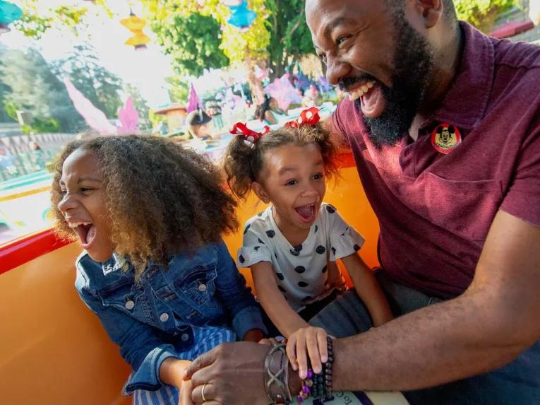 Father and daughters on Mad Tea Party, Disneyland Park in California