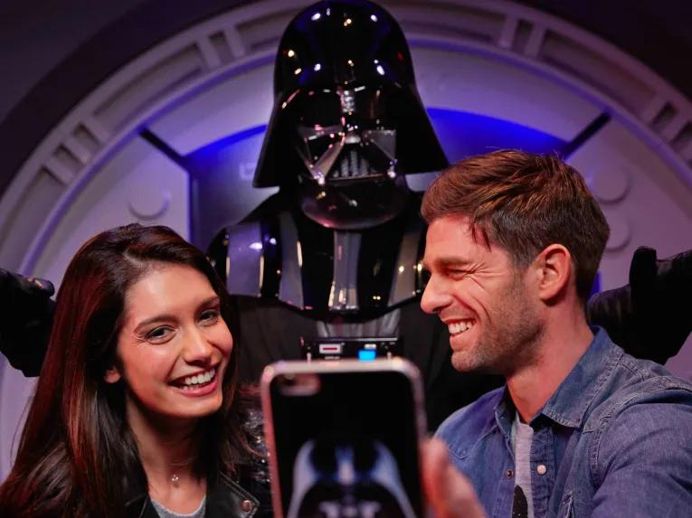 Guests taking a selfie with Darth Vadar at Disneyland Paris