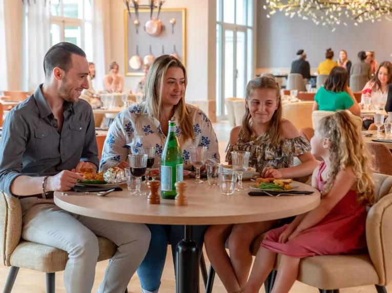Family enjoying refreshments in the Dream Castle Hotel Paris lounge area