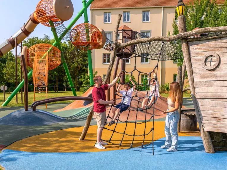 Family enjoying the outdoor play area at Explorers Hotel Marne-la-Vallée