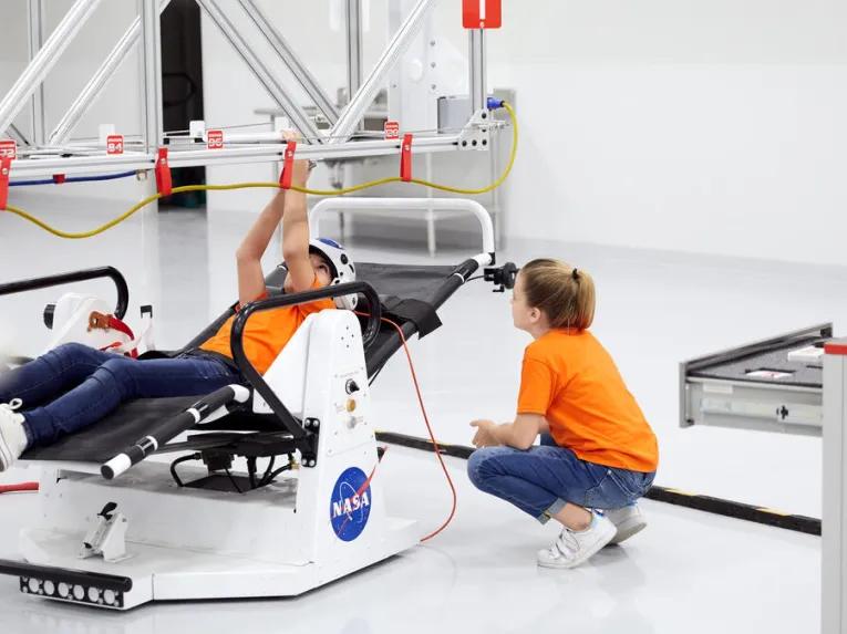 Guests experiencing ATX Microgravity Simulator 11 at Kennedy Space Center Visitor Complex