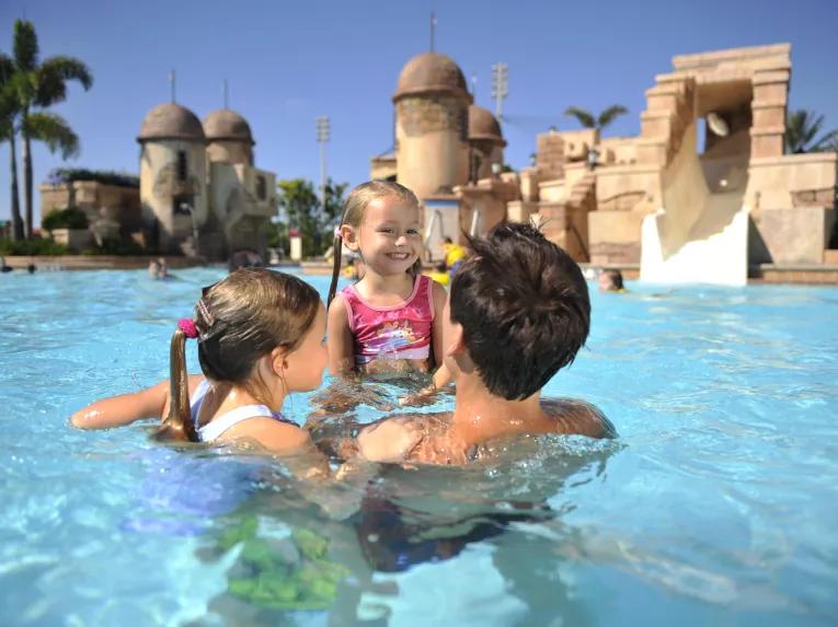 Girls and dad in pool at Disney's Caribbean Beach Resort