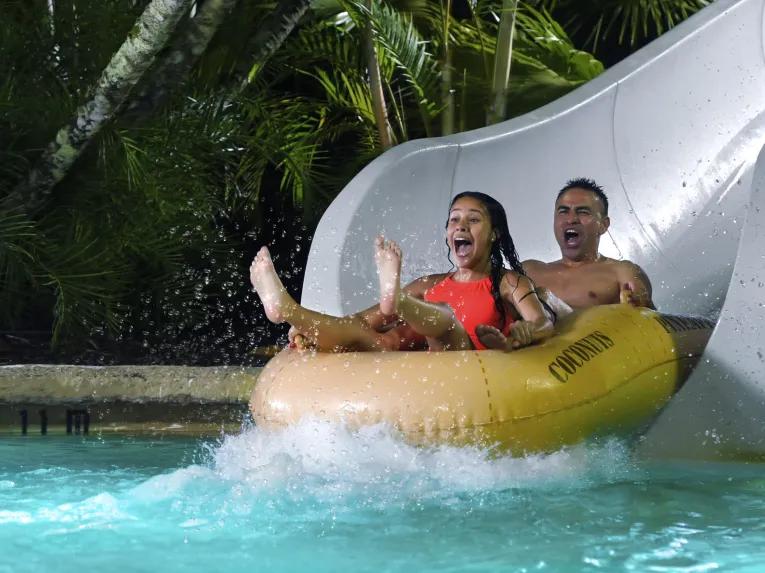 Guests on water slide, Disney H2O Glow Nights at Disney’s Typhoon Lagoon