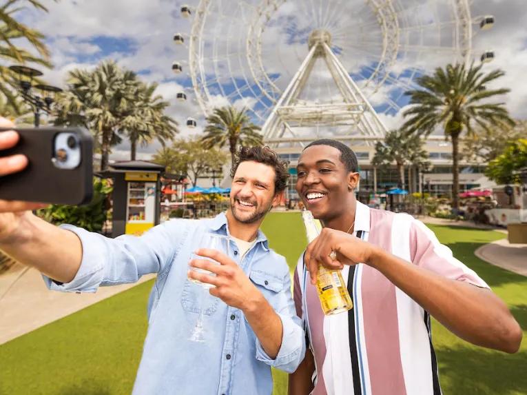 Guests taking a selfie in front of the Orlando Eye