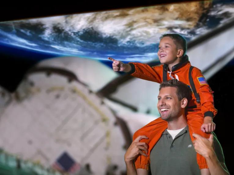 Father and son at Space Shuttle Atlantis exhibit, Kennedy Space Center