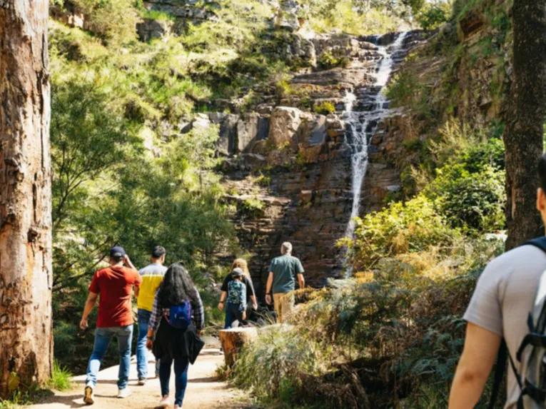 People walking through Silverband Falls