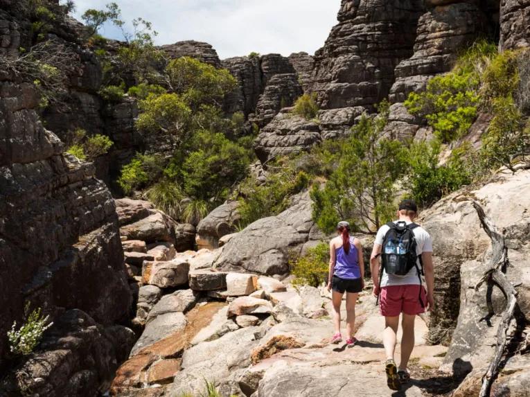 Two people walking through Grand Canyon