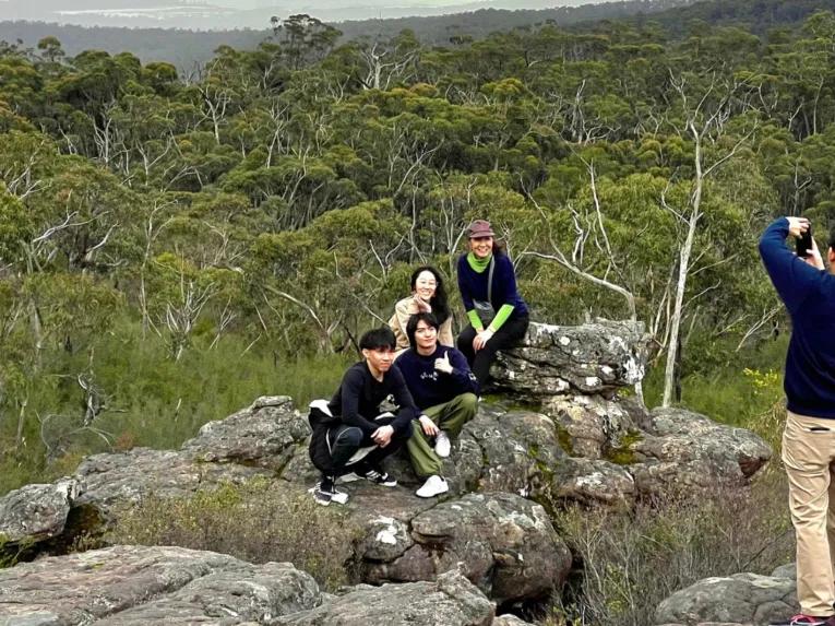 A group smiling whilst having their photo taken at Reeds Lookout