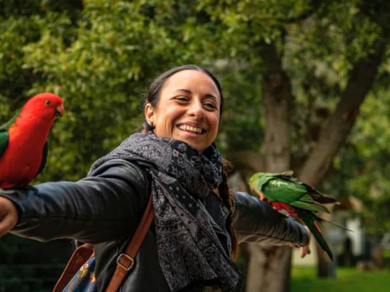 Woman enjoying bird encounter at Kennett River, Great Ocean Road