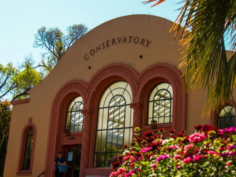 The Conservatory in Fitzroy Gardens during the Melbourne City Discovery Tour, surrounded by colourful floral displays.