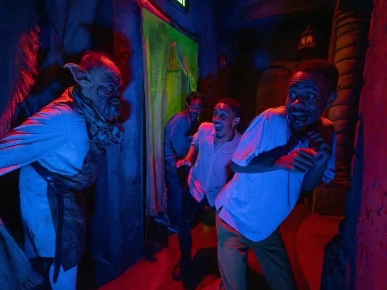 Guests in a scare house at Universal Orlando Halloween Horror Nights