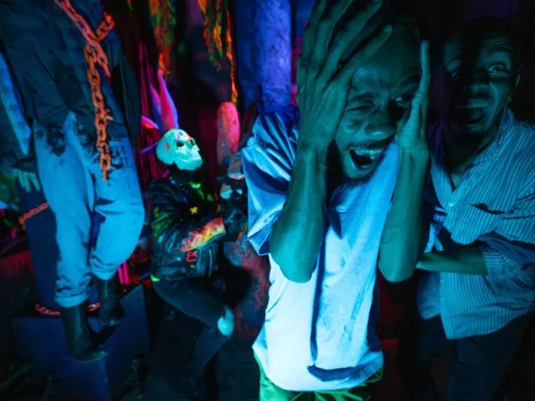 Guests in scare house at Universal Orlando Halloween Horror Nights