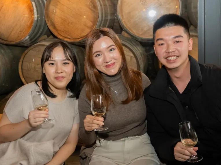 Three people enjoying themselves while holding wine glasses at Rochford Wines