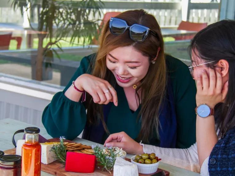 Two women enjoying local food on the Yarra Valley Grazing Tour