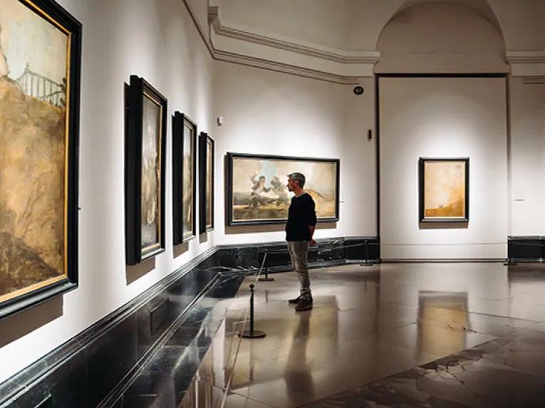 Man looking at art in the Prado