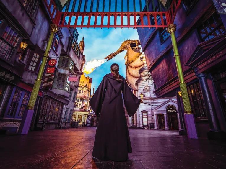 Girl in Harry Potter cloak in front of Gringott's Bank, Universal Studios Florida