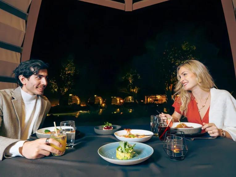 Couple enjoying a romantic dinner on the Platinum Desert Safari
