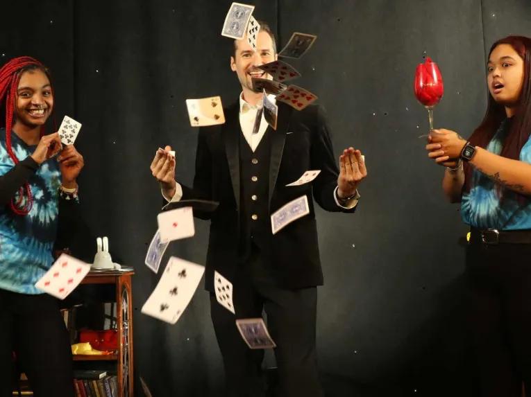 Magician performing card tricks at The Outta Control Magic Dinner Show Orlando