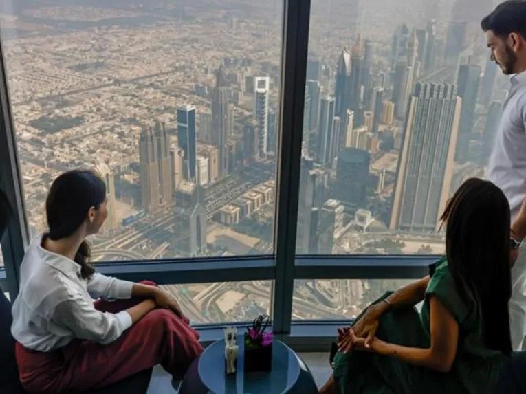 Visitors enjoying panoramic views of Dubai from Burj Khalifa Sky 148th Floor Observation Deck