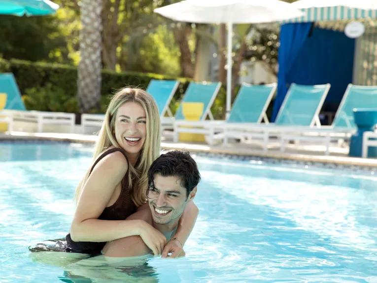 Couple in the pool at the Hilton Orlando Buena Vista Palace Disney Springs® Area