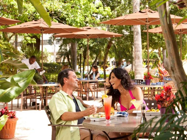 Guests dining on an outside terrace at Hilton Orlando Lake Buena Vista Disney Springs® Area