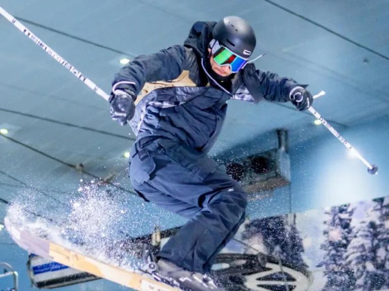 Skier soaring through the air while performing a trick at Ski Dubai