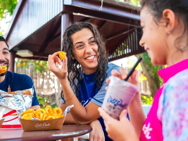 Family enjoying a meal together at Wild Wadi Waterpark