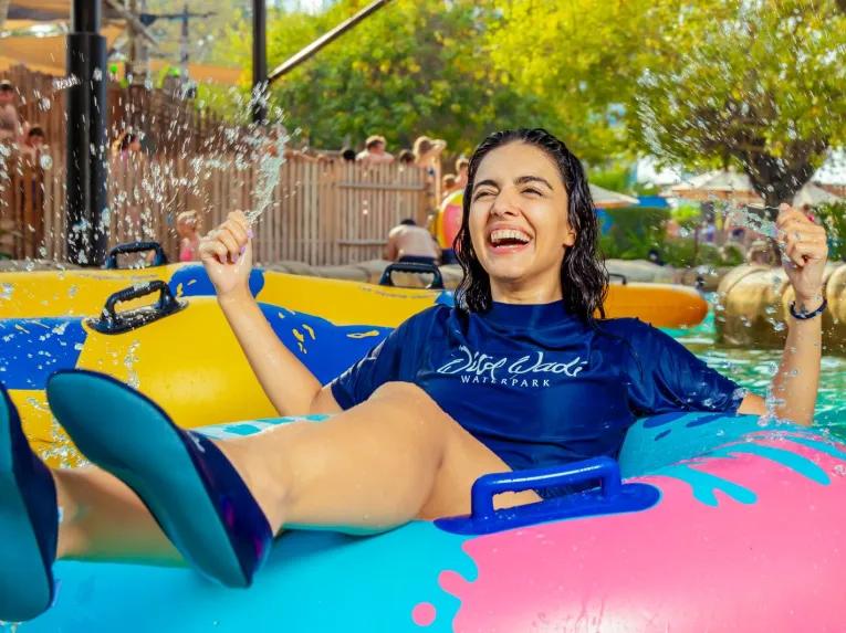 A person smiling and having fun in the water at Wild Wadi Waterpark