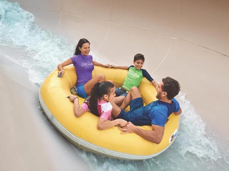 Family of four riding together in a water ring at Wild Wadi Waterpark