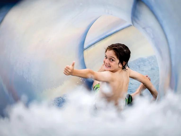 Child enjoying a water slide at Four Seasons Orlando