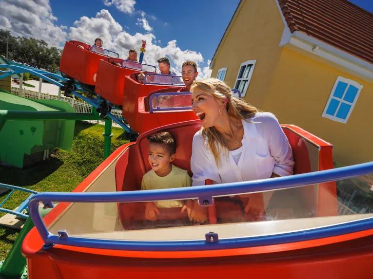 Guests on Daddy Pig’s Roller Coaster at Peppa Pig theme Park in Florida