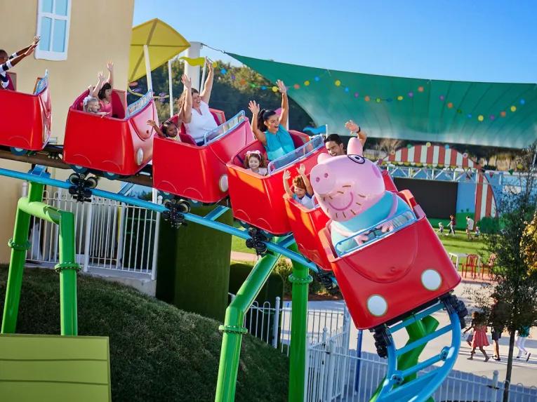 Guests on Daddy Pig's Roller Coaster at Peppa Pig Theme Park in Florida