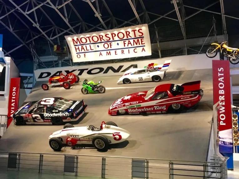 Racing exhibits and historic vehicle displays at Daytona International Speedway.