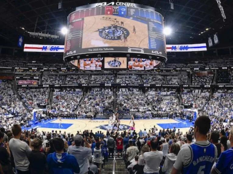 Packed Kia Center arena during an Orlando Magic home game with fans standing and watching