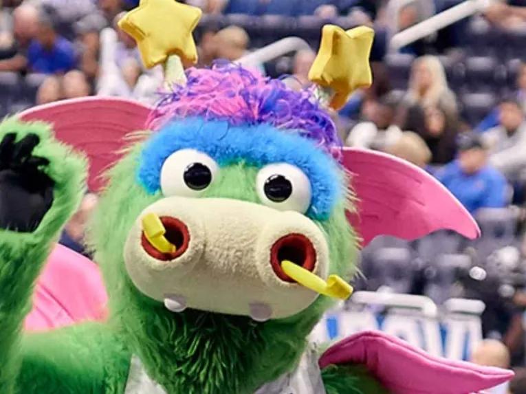 Stuff the Magic Dragon, Orlando Magic mascot, waving to fans at Kia Center